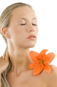 soft portrait of a cute and sweet girl with an orange flower keeping her eyes closed
