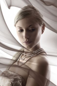 desaturate portrait of cute young woman with pearl necklace