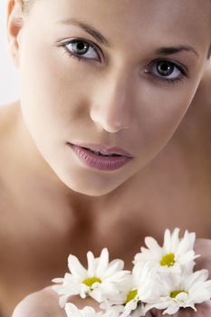 close up of beautiful woman with big eyes and some white daisy