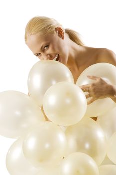 pretty young blond woman with balloons in act to bite a air ballon