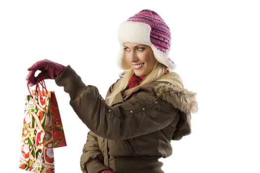 pretty blond girl in winter dress with hat and gloves in act to give christmas present