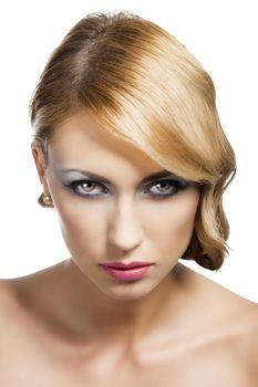 blond beautiful woman with strong make up and an old fashion hair stylish in beauty portrait close up, she is in front of the camera, looks in to the lens with actractive expression