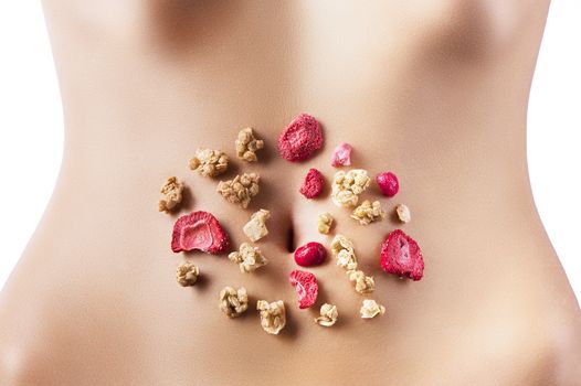 pieces of puffed wheat, cranberries and dried strawberries placed around the navel