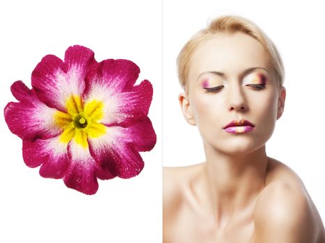 beauty young girl with a floral makeup. She is turned of three quarters and looks in to the lens with attractive expression