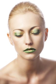 beauty young girl with a floral makeup. She is turned of three quarters and looks in to the lens with attractive expression