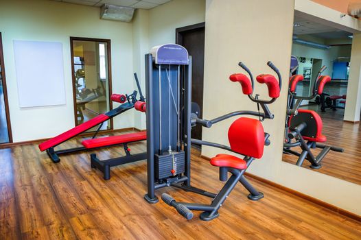 abs machine and other equipment in gym interior
