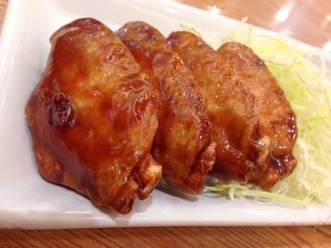 fried chicken wing with teriyaki sauce , japanese food