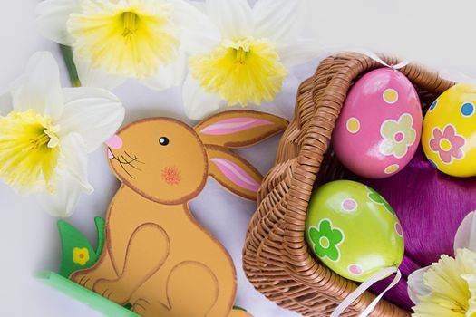 Easter decoration with rabbit, narcissus and eggs