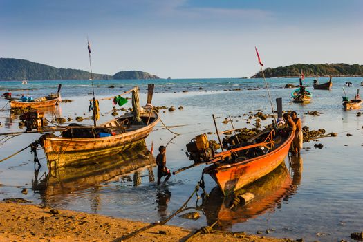 Fishing boats on the sea shore in Phuket, Thailand