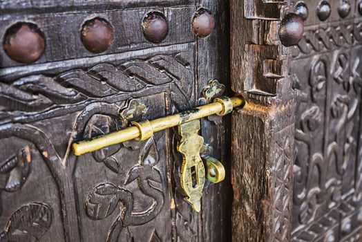 old lock on a wooden carved door