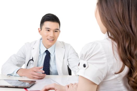 Asian doctor man talking to a woman in hospital office.