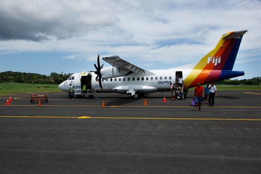 Passangers getting out of Pacific Sun airplane, Labasa airport, Vanua Levu island, Fiji, South Pacific