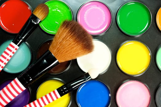 set of make up brushs on colourful scene,shallow focus