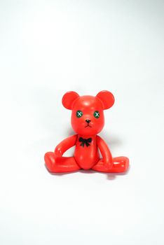 red plastic bear on white scene