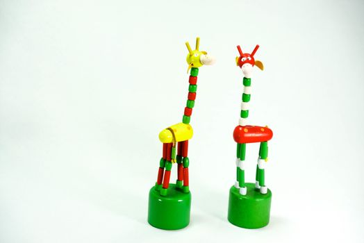 colourful wooden girafe on white scene