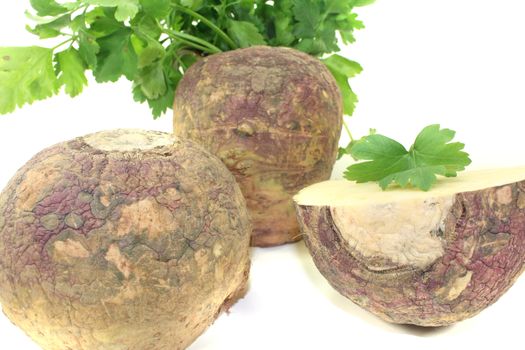 yellow rutabaga with parsley and napkin on a light background