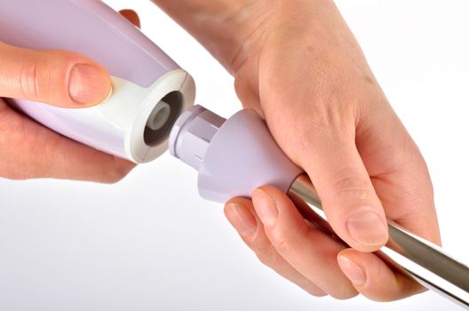 Isolated hand blender in woman hand