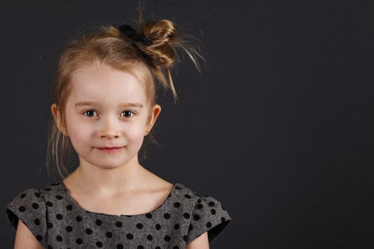 Six years old girl posing in the studio