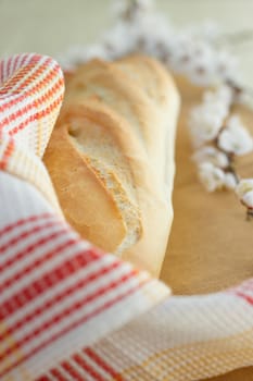 White bread loaf near the napkins on the table