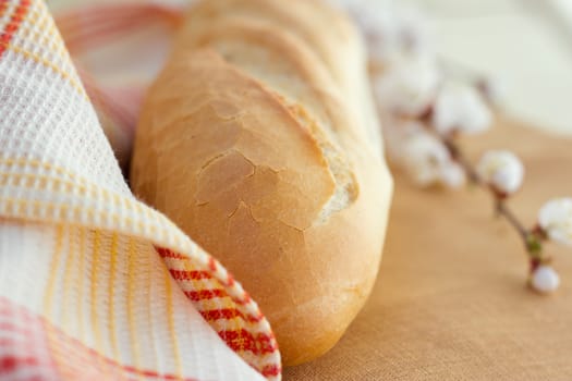 White bread loaf near the napkins on the table