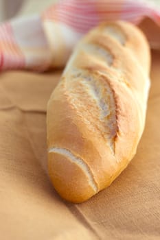 White bread loaf near the napkins on the table