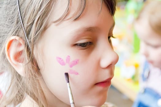Photo of preschooler with flower on the cheek