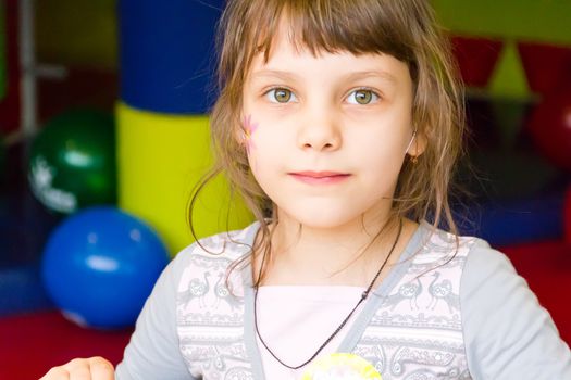 Portrait of cute younger schoolgirl with blue eyes