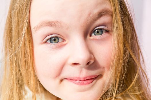 Portrait of cute smiling girl with blond hair