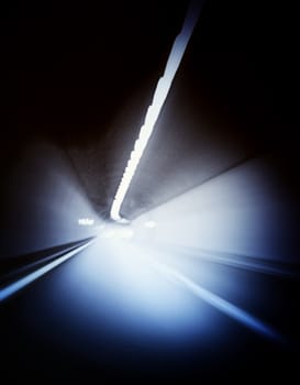 Car lights trails in a tunnel