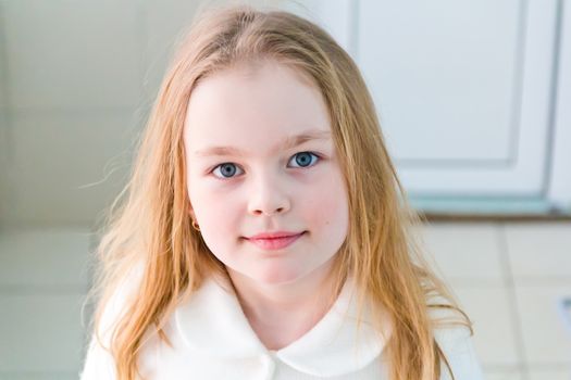 Portrait of cute girl with blond hair