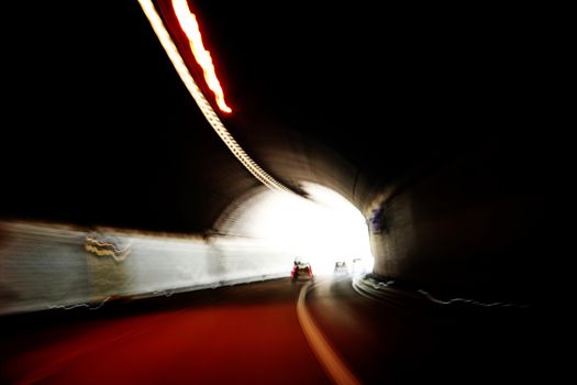 Car lights trails in a tunnel