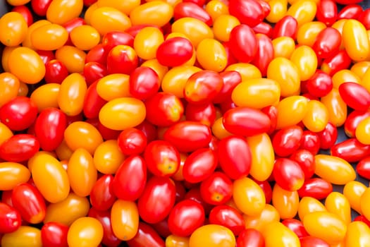 Photo of background with fresh red and yellow tomatos