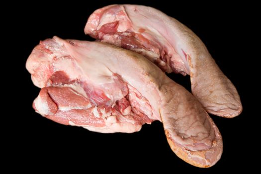 Photo of raw pork tongue on black background