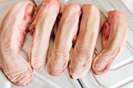 Photo of raw pork tongue in the market place