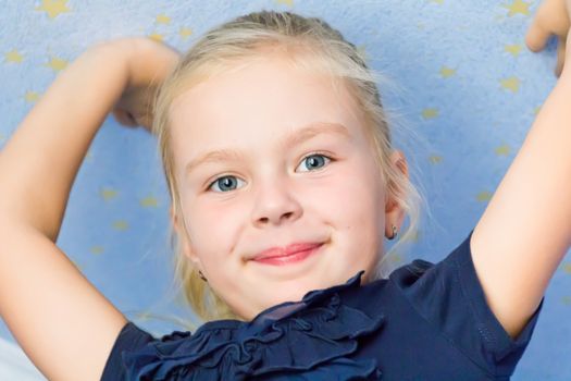 Cute girl seven years old with upward hands