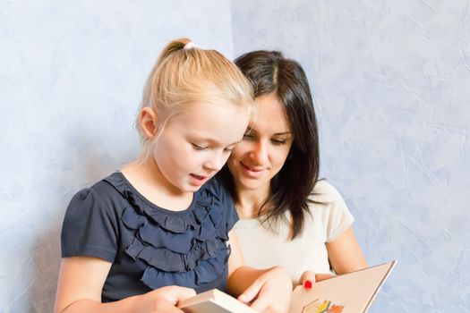 Photo of mother and daughter is younger schoolgirl