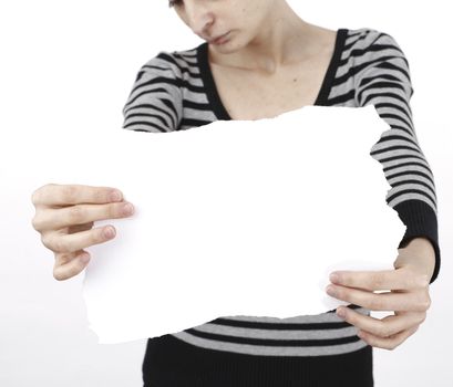 Young blonde woman holding a blank piece of paper.