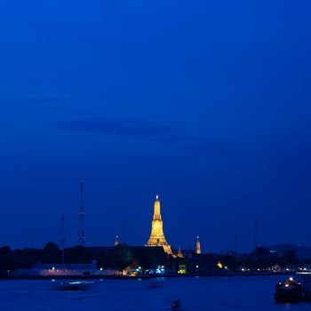 Pagoda Temple in the evening. Atmosphere near darkness. The sky is dark. And pagodas lit.