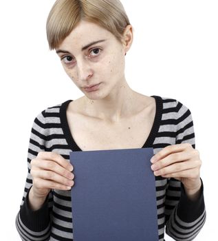 Young blonde woman holding a blank piece of paper.