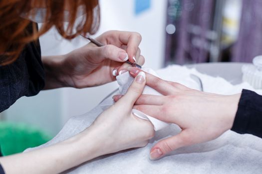 Creating a manicure, cuticle removal tool pusher shot closeup