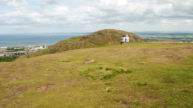 Arthur's Seat is the main peak of the group of hills which form most of Holyrood Park. It is situated in the centre of the city of Edinburgh, about a mile to the east of Edinburgh Castle. The hill rises above the city to a height of 250.5 m (822 ft), provides excellent panoramic views of the city, is relatively easy to climb, and is popular for hillwalking.
