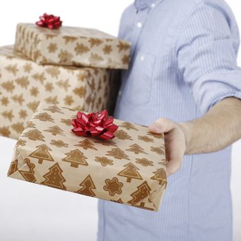 Young man holding a present in hands.