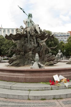 The Neptune Fountain in Berlin was built in 1891 and was designed by Reinhold Begas. The Roman god Neptune is in the center. The four women around him represent the four main rivers of Prussia: Elbe, Rhine, Vistula, and Oder.