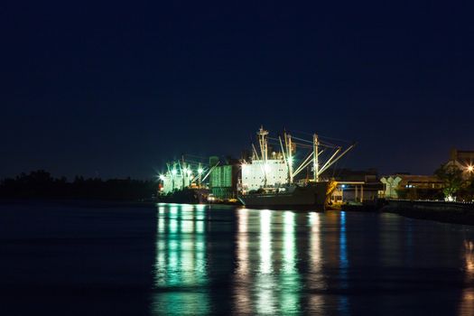Shipping port at night. Cargo ship to dock at night.