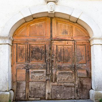 Aged retro decorated brown vintage wooden door.