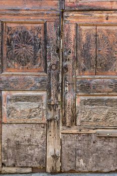 Aged retro decorated brown vintage wooden door.