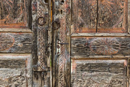 Aged retro decorated brown vintage wooden door.