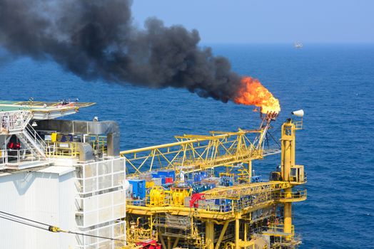 The gas flare is on the offshore oil rig platform