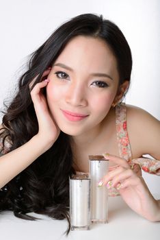 portrait of beautiful smiling healthy asian woman model with cosmetic container