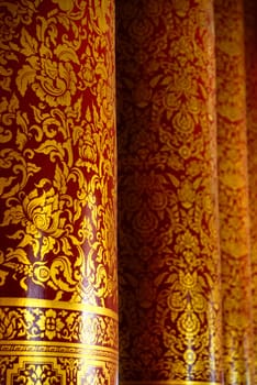 the detail of  thai style gold painting on temple pillars for decoration,shallow focus